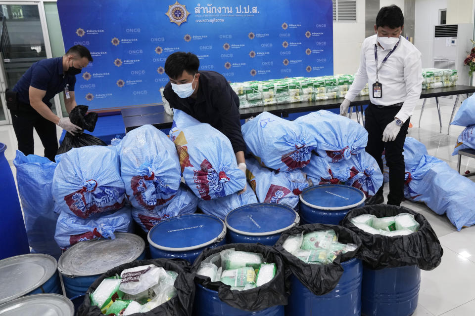 Thai officers display seized crystal methamphetamine which were disguised as packages of tea during a news conference in Bangkok, Thailand, Thursday, June 1, 2023. The huge trade in illegal drugs originating from a small corner of Southeast Asia shows no signs of slowing down, the United Nations Office on Drugs and Crime warned Friday. (AP Photo/Sakchai Lalit)