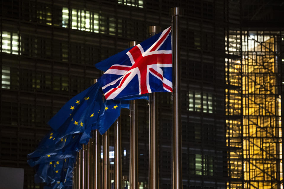 FILE - In this Wednesday, Dec. 9, 2020 file photo,the Union Flag and European Union flags flap in the wind prior a meeting between European Commission President Ursula von der Leyen and British Prime Minister Boris Johnson at EU headquarters in Brussels. Across the English Channel, Brexit supporters in British politics and the media often depict a conniving EU, deeply hurt by the U.K.'s decision to leave, and doing its utmost to make Brexit less than a success by throwing up bureaucratic impediments. (AP Photo/Francisco Seco, File)