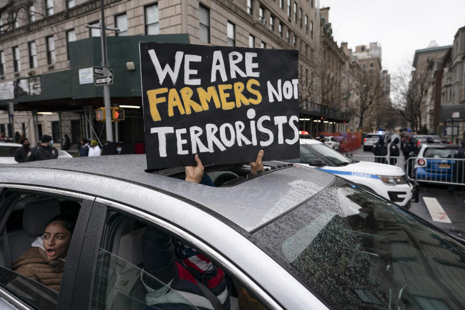 A convoy of protesters drive down Fifth Avenue past the Consulate General of India, Tuesday, Jan. 26, 2021, in the Manhattan borough of New York. Tens of thousands of protesting farmers have marched, rode horses and drove long lines of tractors into India's capital, breaking through police barricades to storm the historic Red Fort. The farmers have been demanding the withdrawal of new laws that they say will favor large corporate farms and devastate the earnings of smaller scale farmers. Republic Day marks the anniversary of the adoption of India’s constitution on Jan. 26, 1950. (AP Photo/John Minchillo)