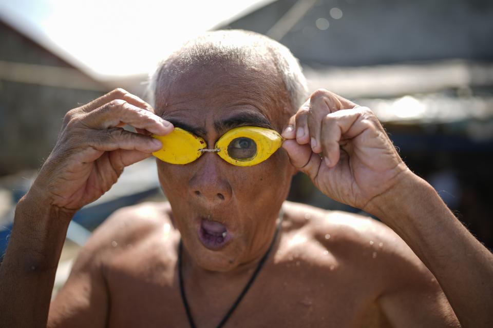 Jesus Culis adjusts his swimming goggles at the coastal village of Simlong in Batangas province, Philippines on Tuesday, Aug. 8, 2023. He lost his vision on one eye during a childhood accident. (AP Photo/Aaron Favila)