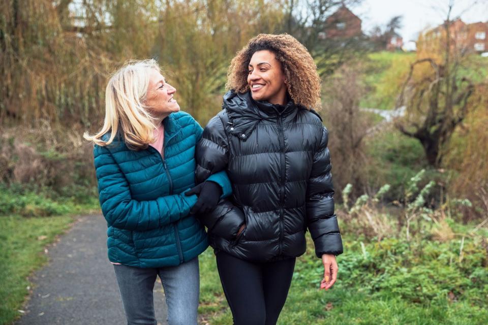 two woman walking outside in cold weather