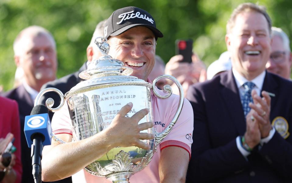 Justin Thomas hugs the Wanamaker Trophy following his three-hole play-off victory - GETTY IMAGES