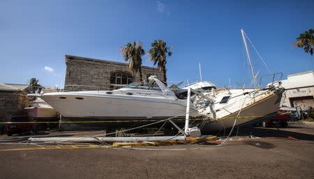 Boats lie damaged after Hurricane Gonzalo passed through Royal Naval Dockyard, western Bermuda, October 18, 2014. REUTERS/Nicola Muirhead
