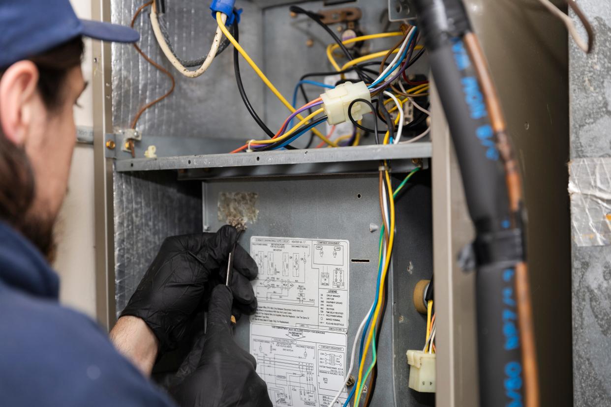 Jeremy Linehan, a technician at Boothe’s Heating & Air, services an HVAC system after biological growth was found on the inside of the unit.