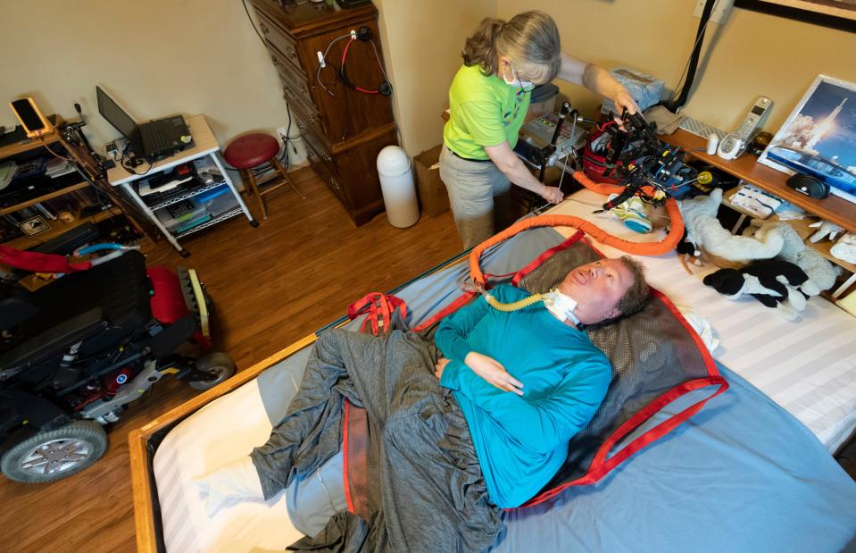 Private duty nurse Julie DuBois gets Timothy Carey settled in bed Saturday at his home in Grand Chute. Voting in person is extremely difficult for Carey because he has advanced Duchenne muscular dystrophy and in unable to move his body. He would need to bring a portable ventilator and a "boatload of gear" with him to go to the polls, he said. Voting in person would increase the chances he would get COVID, which could easily kill him because of his disability.