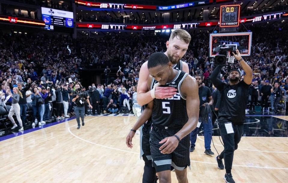 Sacramento Kings center Domantas Sabonis (10) hugs teammate guard De’Aaron Fox (5) after their victory in Game 2 of the first-round NBA playoff series at Golden 1 Center on Monday, April 17, 2023.