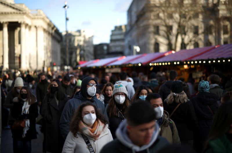 People walk through a Christmas market in Trafalgar Square, in London