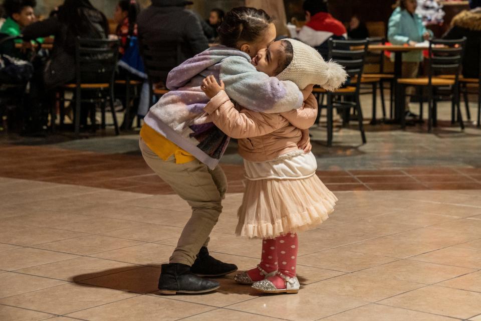 The Paterson Police Department is using a grant to give gift cards to families at the Center City Mall in Paterson, NJ on Wednesday, Dec. 21, 2022. Sisters Naya Rivera and Nayelis Rivera hug in the food court after going shopping. 