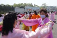 Women dance near the Arch of Triumph on the Day of the Sun, the birth anniversary of late leader Kim Il Sung, in Pyongyang, North Korea Thursday, April 15, 2021. (AP Photo/Jon Chol Jin)