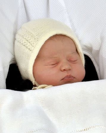 Charlotte Elizabeth Diana, the baby daughter of Britain's Prince William and Catherine, Duchess of Cambridge, sleeps as she is carried in a car seat from the Lindo Wing of St Mary's Hospital, in London, Britain May 2, 2015. REUTERS/John Stillwell/pool