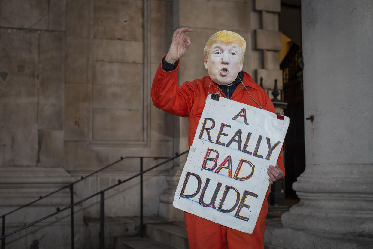 A man wearing an orange prison outfit and a Donald Trump mask during a protest against U.S. President Donald Trump UK visit to attend the NATO (North Atlantic Treaty Organisation) summit on the 3rd December 2019 in London in the United Kingdom. Ahead of a British national election on 12th December 2019, Stop Trump Coalition and CND, (Campaign for Nuclear Disarmament) organised a protest to target a banquet at Buckingham Palace where Trump will dine with the Queen and other NATO leaders. The U.K. is hosting NATO summit to mark the military alliance's 70th anniversary. (photo by Sam Mellish / In Pictures via Getty Images)