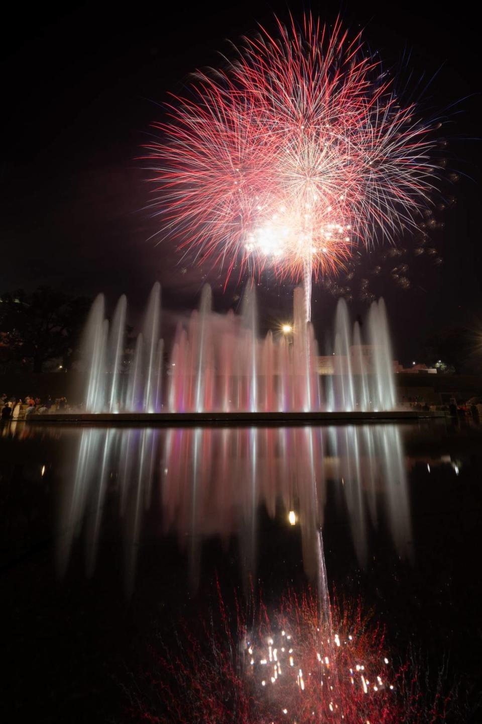 Fireworks burst over the tower at the National WWI Musuem and Memorial and the Henry Wollman Bloch Fountain Thursday in Kansas City.