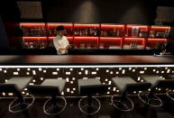 A waiter works in a bar at First Cabin hotel, which was converted from an old office building, in Tokyo, July 3, 2015. REUTERS/Toru Hanai