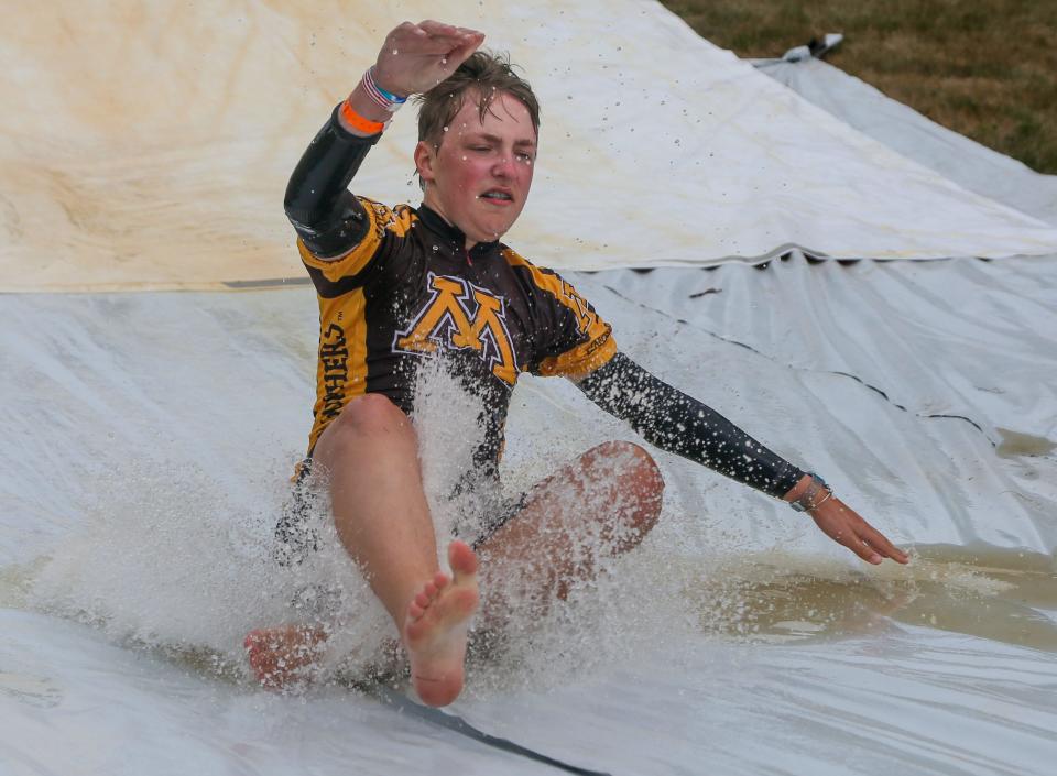 Hayden Behren of West Des Moines cools off on a Slip and Slide outside Nemaha on the second day of RAGBRAI in 2022.