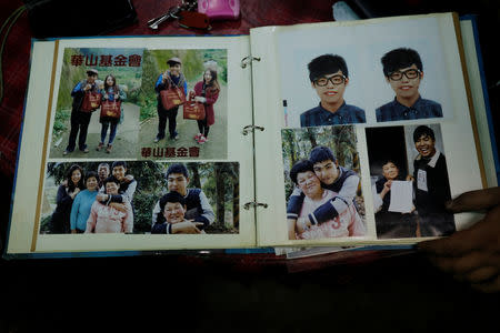 Old photographs of 26-year-old Chen Hong-zhi who suffers from short-term memory loss, are seen in a photo album at his home in Hsinchu, Taiwan, July 2, 2018. REUTERS/Tyrone Siu