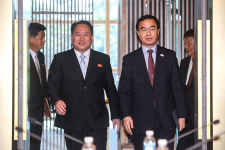 South Korean Unification Minister Cho Myoung-gyon and his North Korean counterpart Ri Son Gwon arrives for their meeting at the truce village of Panmunjom, South Korea, June 1, 2018. Yonhap via REUTERS