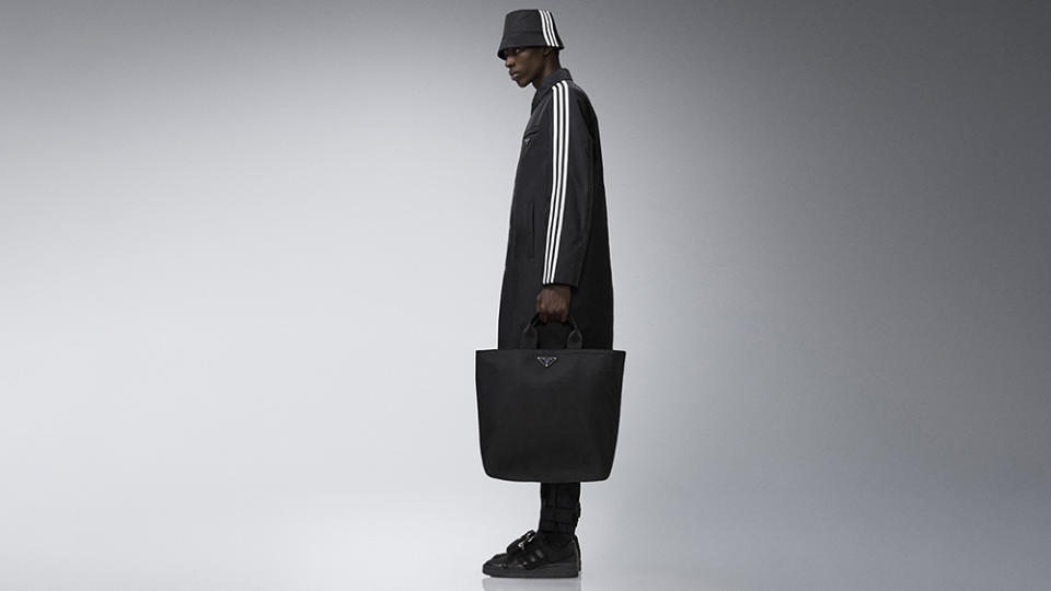 An all-black fit from the drop including a striped hat and jacket, a tote bag, and sneakers. - Credit: Adidas