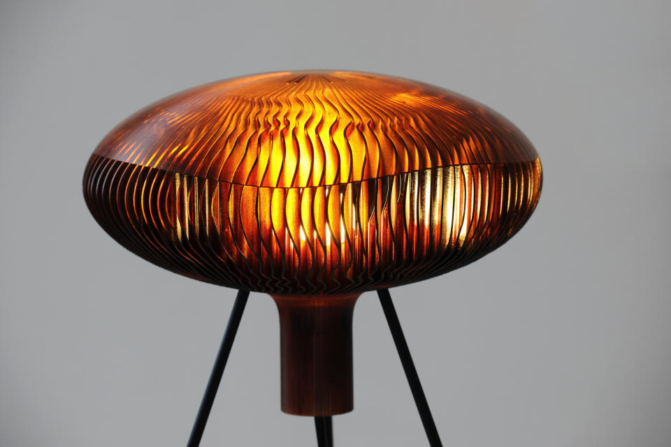 This photo provided by .MGX by Materialise shows the Russula.MGX table lamp by Arik Levy, from the design division of Belgium-based 3-D printing company, Materialise. It takes its name and shape from a mushroom, appearing to float and hover in space thanks to a slender supporting structure. A novelty once reserved for science-fiction, 3-D printing has gone mainstream in home decor thanks to cheaper, more accessible technology. (AP Photo/.MGX by Materialise)