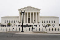 Supreme Court Associate Justice Ketanji Brown Jackson stands outside the Supreme Court, at the top of the steps, with Chief Justice of the United States John Roberts, following her formal investiture ceremony at the Supreme Court in Washington, Friday, Sept. 30, 2022. (AP Photo/Carolyn Kaster)