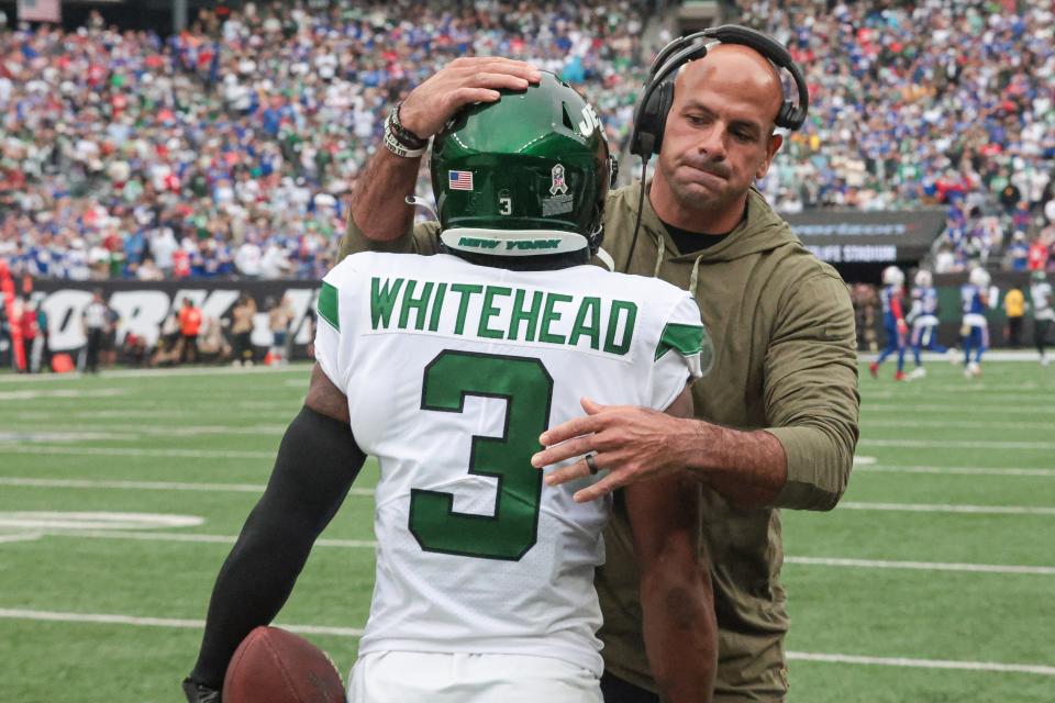 New York Jets head coach Robert Saleh celebrates with safety Jordan Whitehead (3) after his interception against the Buffalo Bills.