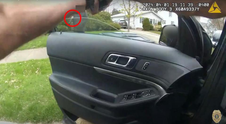 In this screen grab, the fake gun carried by Tavion Koonce-Williams can be seen a moment before he was shot in the hand by Akron Police Officer Ryan Westlake.
