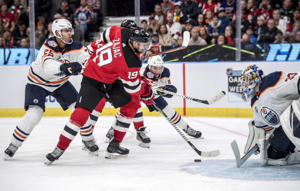 New Jersey Devils' Travis Zajac scores during the season-opening NHL Global Series hockey match between Edmonton Oilers and New Jersey Devils at Scandinavium in Gothenburg, Sweden, Saturday, Oct. 6, 2018, (Bjorn Larsson Rosvall /TT News Agency via AP)