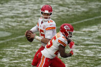 Kansas City Chiefs quarterback Patrick Mahomes looks to throw a pass as running back Clyde Edwards-Helaire fakes the handoff during the second half of an NFL football game against the Denver Broncos, Sunday, Oct. 25, 2020, in Denver. (AP Photo/Jack Dempsey)