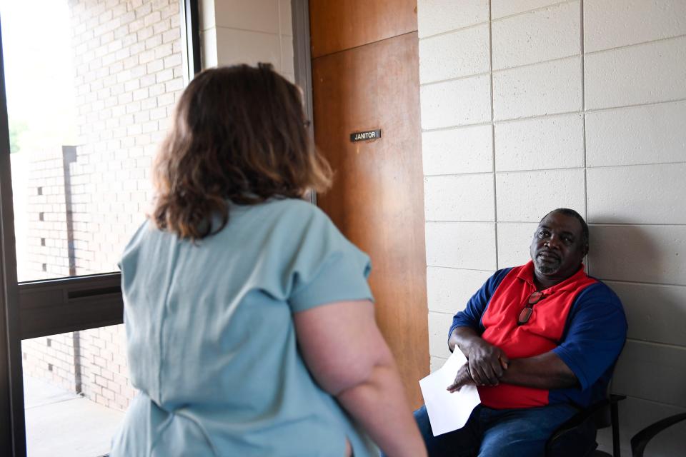 Henry Thomas listens as a Saluda Dam Road Department of Motor Vehicles employee informs him of the issues he needs to resolve before getting his drivers license on Thursday, April 13, 2023.
