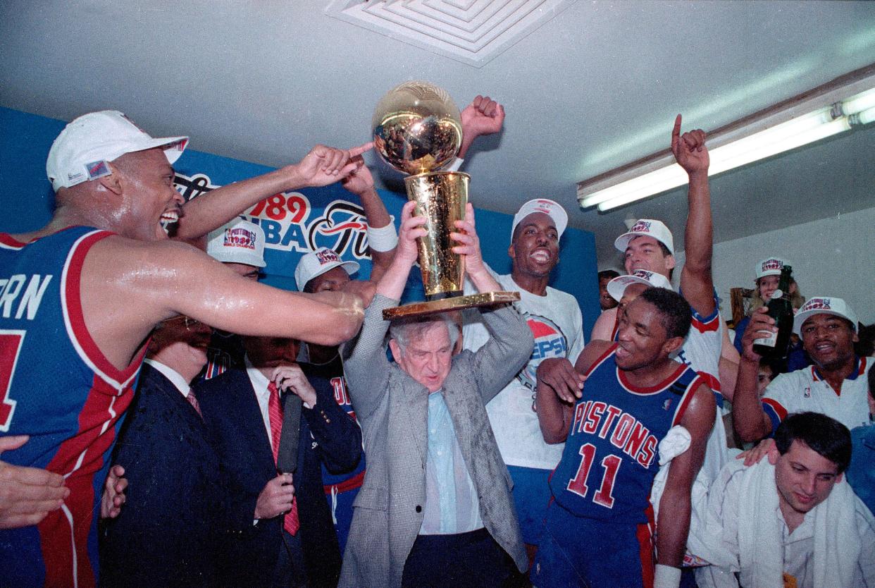 The Detroit Pistons team featuring Isaiah Thomas, Rick Mahorn and Bill Lambeer celebrate their 1989 NBA championship after beating the Los Angeles Lakers.