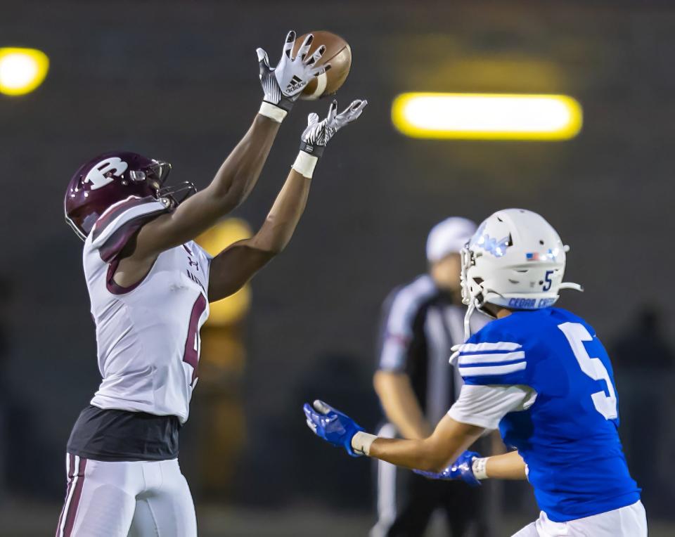 Bastrop wide receiver Keyshon Moore reaches up for a touchdown catch in the first quarter.