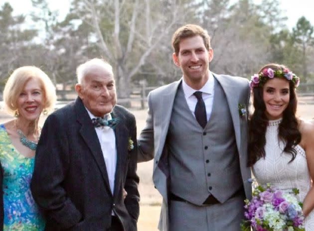 The author poses for a photo at his wedding, next to his wife and his parents.