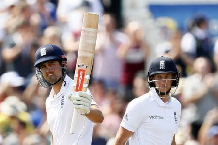 FILE PHOTO: Britain Cricket - England v Pakistan - Second Test - Emirates Old Trafford - 22/7/16 England's Alastair Cook celebrates his half century as Joe Root looks on Action Images via Reuters / Jason Cairnduff Livepic