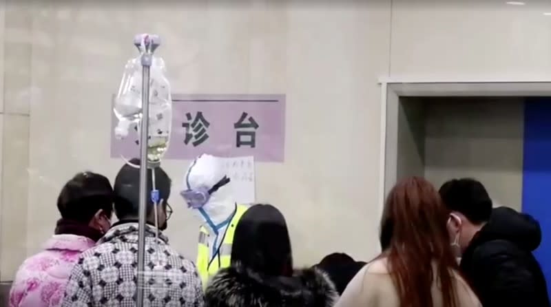 A staff member wearing protective gear is seen at a hospital in Wuhan