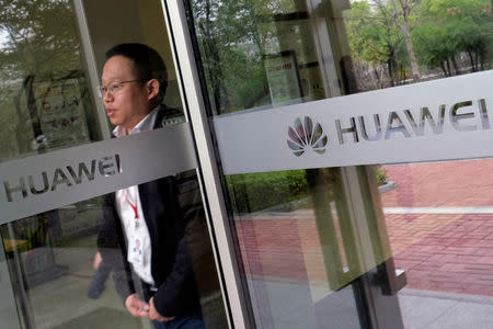 An employee walks inside Huawei's factory campus in Dongguan, Guangdong province, China March 25, 2019. REUTERS/Tyrone Siu