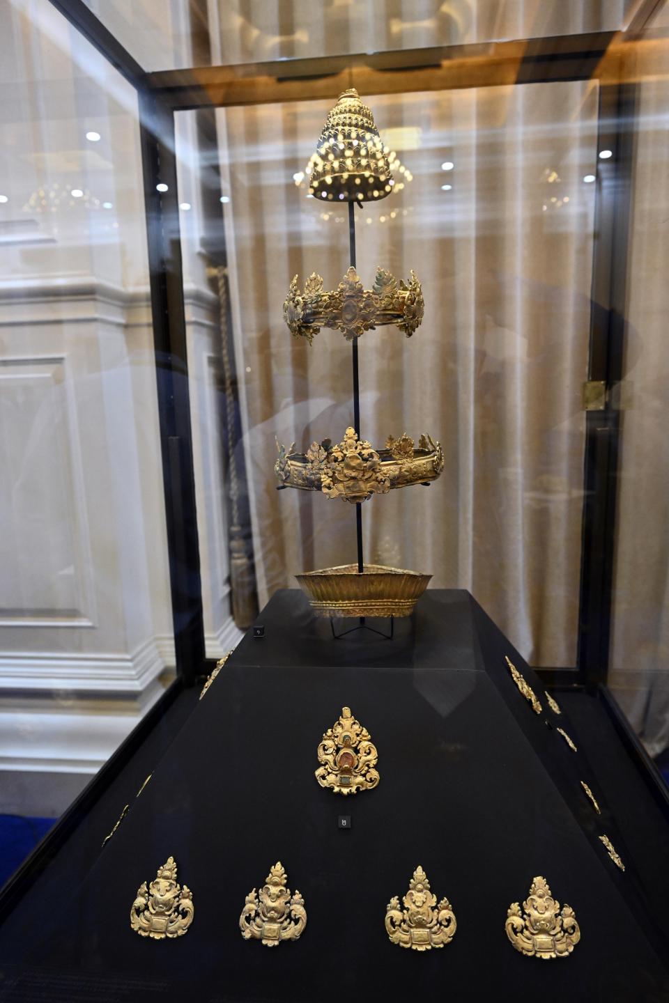 In this photo provided by Kok Ky/Cambodia's Government Cabinet, jewelries are displayed during a handing over ceremony at Peace Palace, in Phnom Penh, Cambodia, Friday, March 17, 2023. Centuries-old cultural artifacts that had been illegally smuggled out from Cambodia were welcomed home Friday at a celebration led by Prime Minister Hun Sen, who offered thanks for their return and appealed for further efforts to retrieve such stolen treasures.(Kok Ky/Cambodia's Government Cabinet via AP)