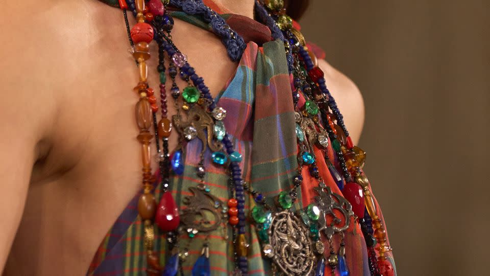 Strands of chunky beading and gems are layered atop a multicolored check bandeau top. - Courtesy Ralph Lauren