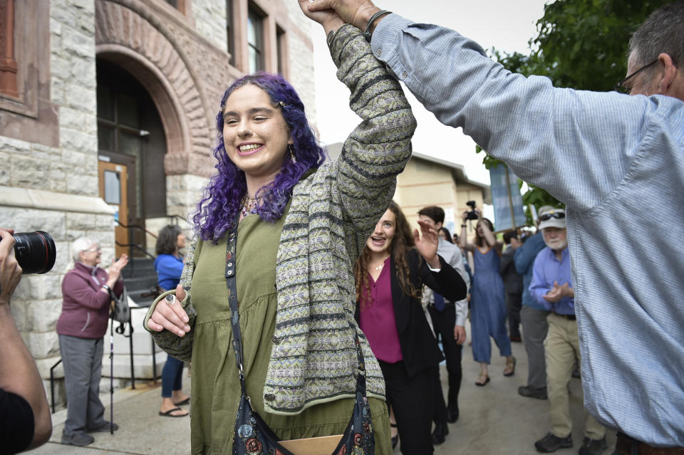 Olivia Vesovich, 19, a plaintiff in the first U.S. trial over a state government's obligation to protect its citizens from climate change, is seen outside the Lewis and Clark County courthouse, Monday, June 12, 2023, in Helena, Mont. A group of Montana youth who say their lives are already being affected by climate change and that state government is failing to protect them are the first of dozens of such efforts to get their lawsuit to trial Monday. (Thom Bridge/Indpendent Record via AP)