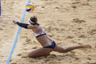 April Ross, of the United States, dives for a shot during a women's beach volleyball match against Germany at the 2020 Summer Olympics, Tuesday, Aug. 3, 2021, in Tokyo, Japan. (AP Photo/Felipe Dana)