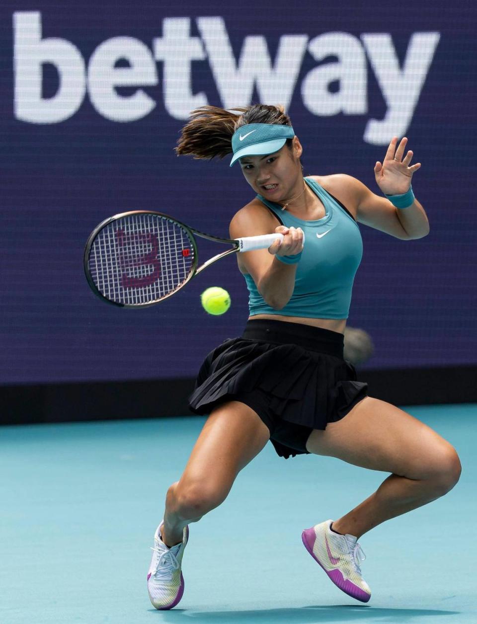 Emma Raducanu of the United Kingdom returns a shot to Bianca Andreescu of Canada during their match at the Miami Open tennis tournament on Wednesday, March 22, 2023, in Miami Gardens, Fla.