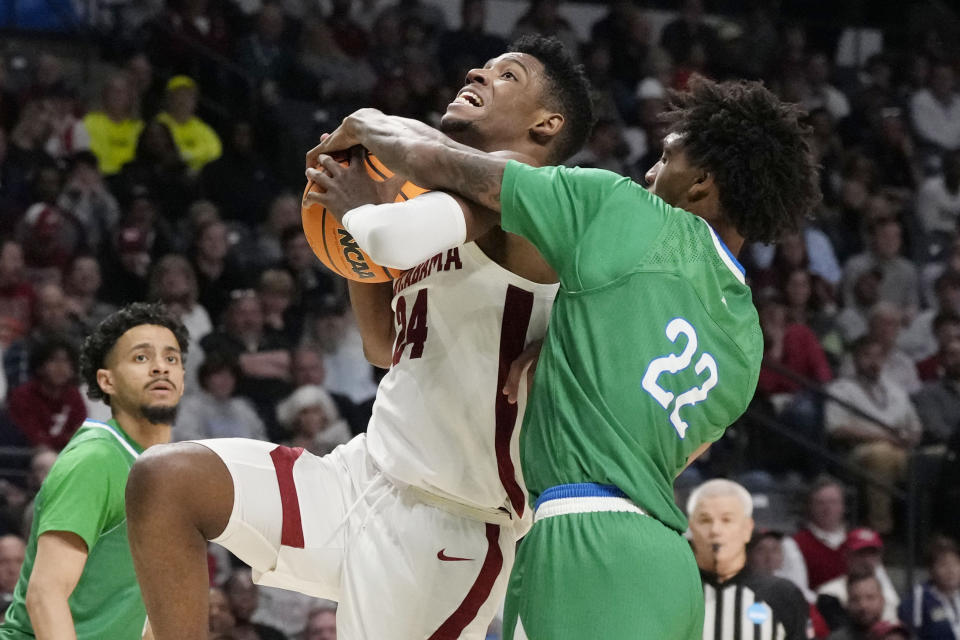 Alabama forward Brandon Miller (24) is fouled by Texas A&M-Corpus Christi guard Simeon Fryer (22) during the second half of a first-round college basketball game in the men's NCAA Tournament in Birmingham, Ala., Thursday, March 16, 2023. Alabama won 96-75. (AP Photo/Rogelio V. Solis)