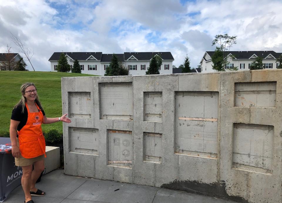 Sara Sorenson, co-founder of the Museum of Markers + Innovators (MOMI), shows off the Creative Canvas, a stone mural where children can draw chalk pictures, as part of the Morris Marketplace Thinkscape at the new marketplace in Morris Township Tuesday, Aug. 8, 2023.