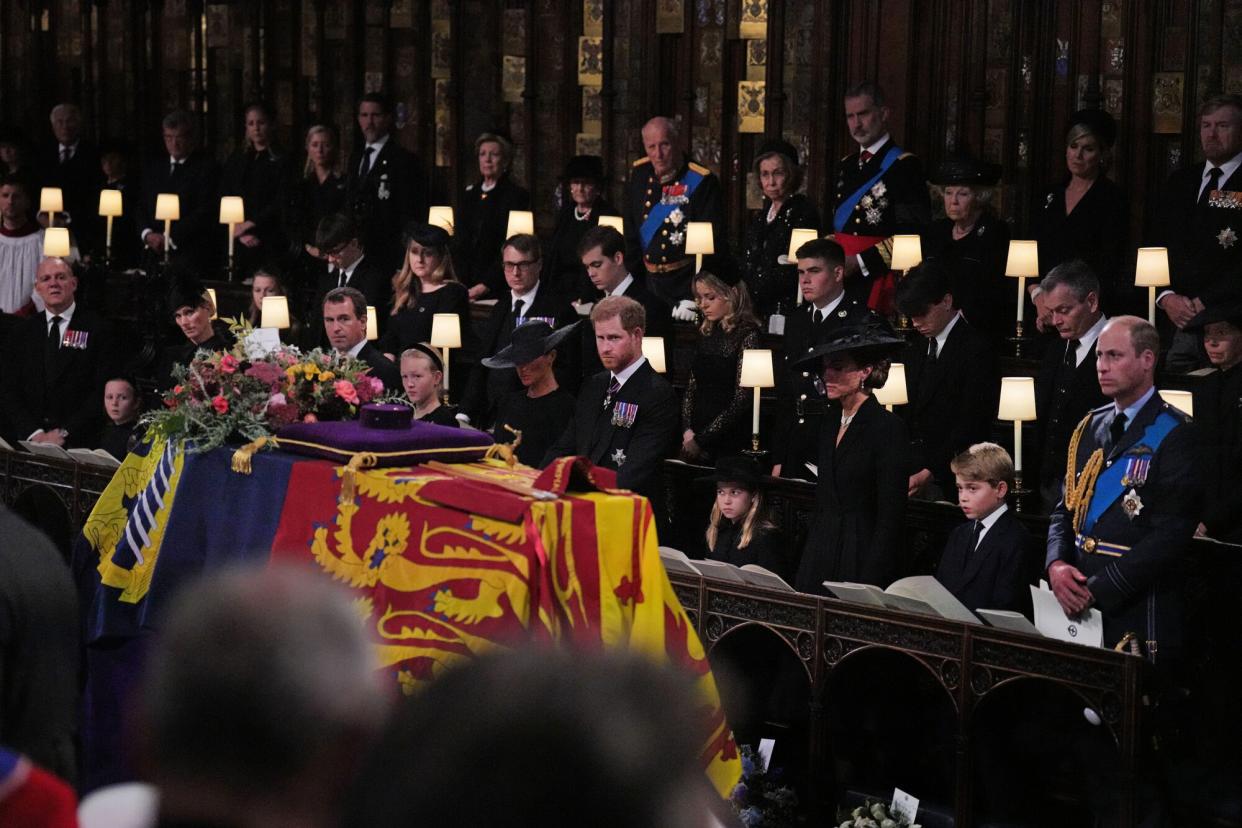 The Duchess of Sussex, the Duke of Sussex, Princess Charlotte, the Princess of Wales, Prince George, and the Prince of Wales during the Committal Service for Queen Elizabeth, at St George's Chapel in Windsor Castle on September 19, 2022 in Windsor, England. The committal service at St George's Chapel, Windsor Castle, took place following the state funeral at Westminster Abbey. A private burial in The King George VI Memorial Chapel followed. Queen Elizabeth II died at Balmoral Castle in Scotland on September 8, 2022, and is succeeded by her eldest son, King Charles III.