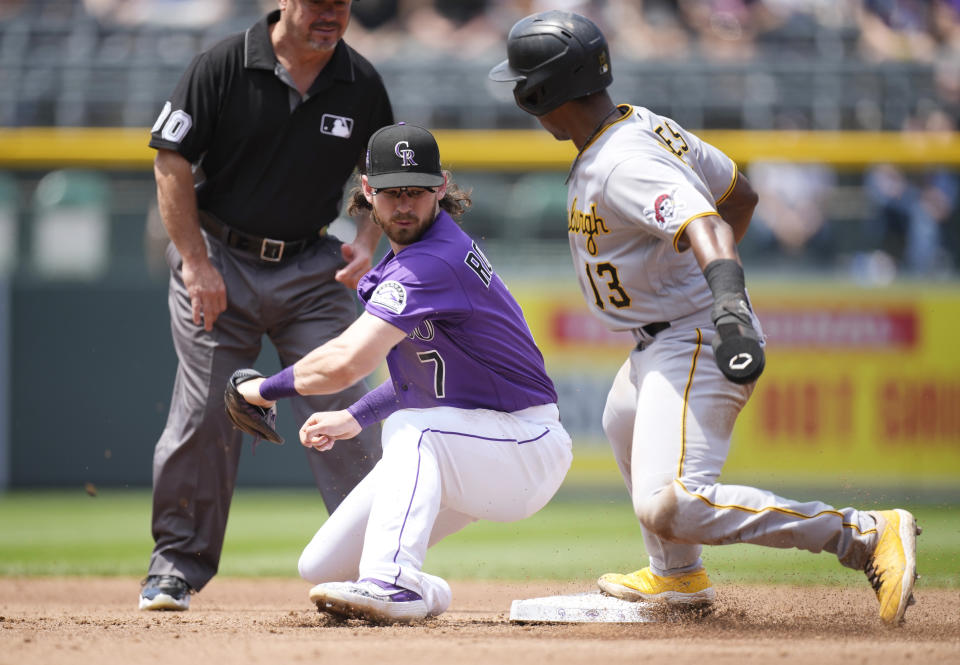 Colorado Rockies shortstop Brendan Rodgers, left, fields the throw as Pittsburgh Pirates' Ke'Bryan Hayes steals second base in the third inning of a baseball game Wednesday, June 30, 2021, in Denver. (AP Photo/David Zalubowski)