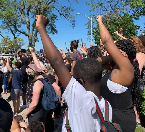 Fists in the air during a moment of silence at the Black Lives Matter rally on Windsor's Riverfront in June 2020.