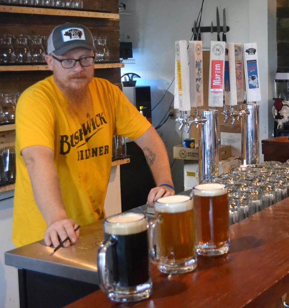 Bartender Brandon Arnold shows off the Oktoberfest offerings at Newport Craft.