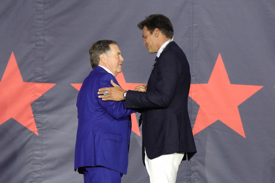 Former New England Patriots quarterback Tom Brady, right, greets former Patriots head coach Bill Belichick, left, on stage during Patriots Hall of Fame induction ceremonies for Brady at Gillette Stadium, Wednesday, June 12, 2024, in Foxborough, Mass. (AP Photo/Steven Senne)