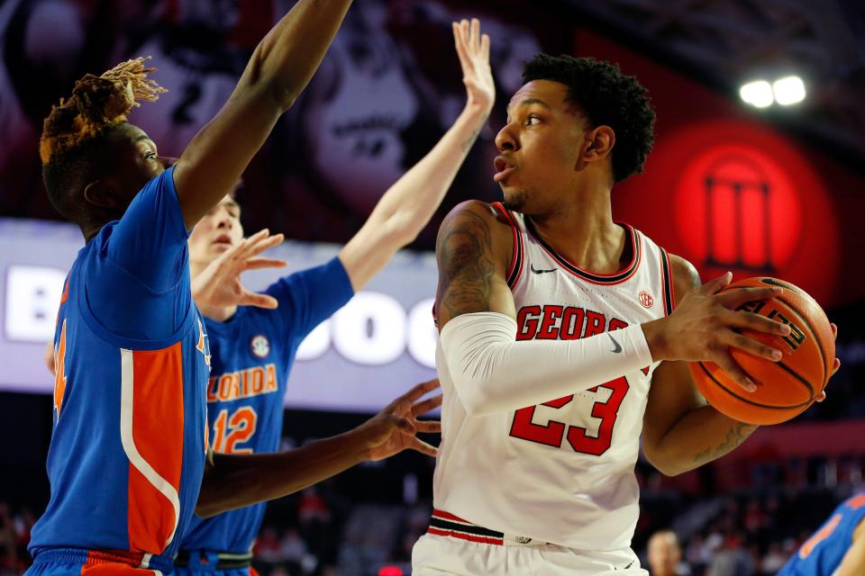 Georgia's Braelen Bridges (23) looks to shoot while being defended by Florida guard Kowacie Reeves (14) during a basketball game between Florida and Georgia in Athens, Ga., on Saturday, Feb. 26, 2022.
