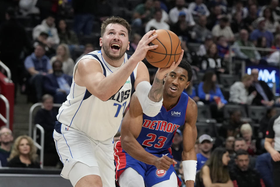 Dallas Mavericks guard Luka Doncic attempts a layup as Detroit Pistons guard Jaden Ivey (23) defends during the second half of an NBA basketball game, Saturday, March 9, 2024, in Detroit. (AP Photo/Carlos Osorio)