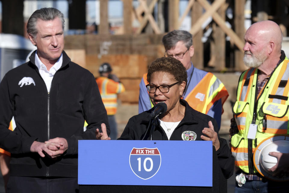 Los Angeles Mayor Karen Bass, center, joined by California Gov. Gavin Newsom, left,, speaks during a news conference about repairs for a stretch of Interstate 10, Tuesday morning Nov. 14, 2023, in Los Angeles. It will take at least three weeks to repair the Los Angeles freeway damaged in an arson fire, the Newsom said Tuesday, leaving the city already accustomed to soul-crushing traffic without part of a vital artery that serves hundreds of thousands of people daily. (Dean Musgrove/The Orange County Register via AP)