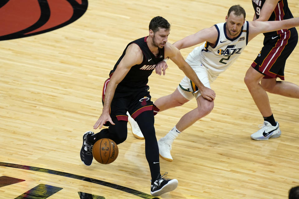 Utah Jazz forward Joe Ingles (2) defends against Miami Heat guard Goran Dragic (7) during the first half of an NBA basketball game, Friday, Feb. 26, 2021, in Miami. (AP Photo/Lynne Sladky)